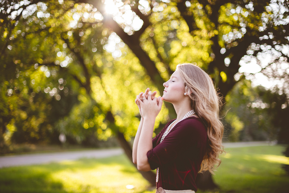 Woman Praying Outdoors